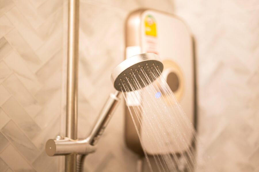 Water,Falling,From,Rain,Shower,Head,With,Electric,Water,Heater
