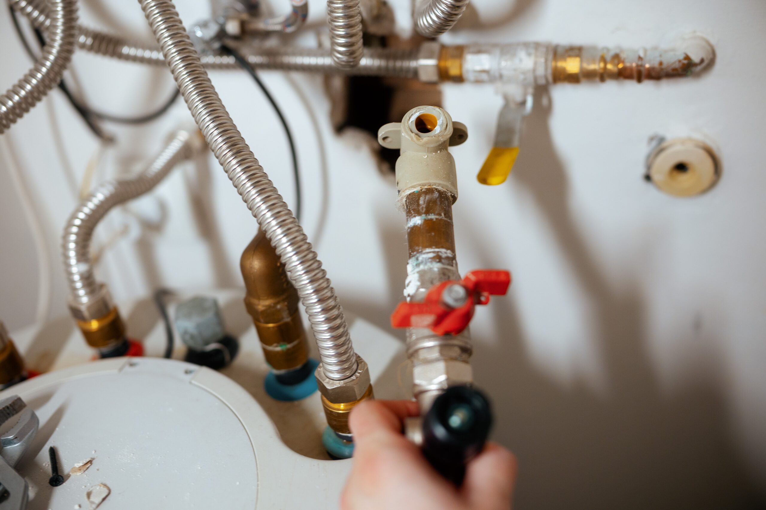 A,Hand,Holds,A,Flashlight,,Illuminating,Section,Of,Water,Heater